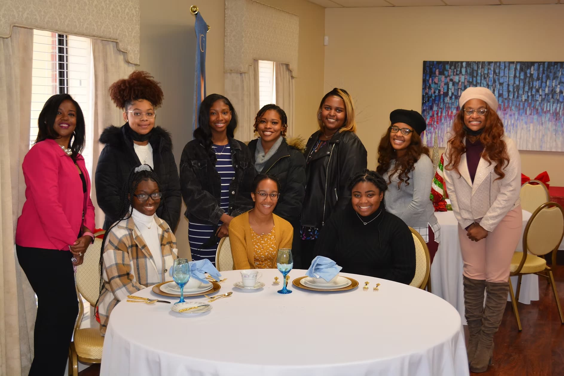 A group gathered around a table set for a dining etiquette session.